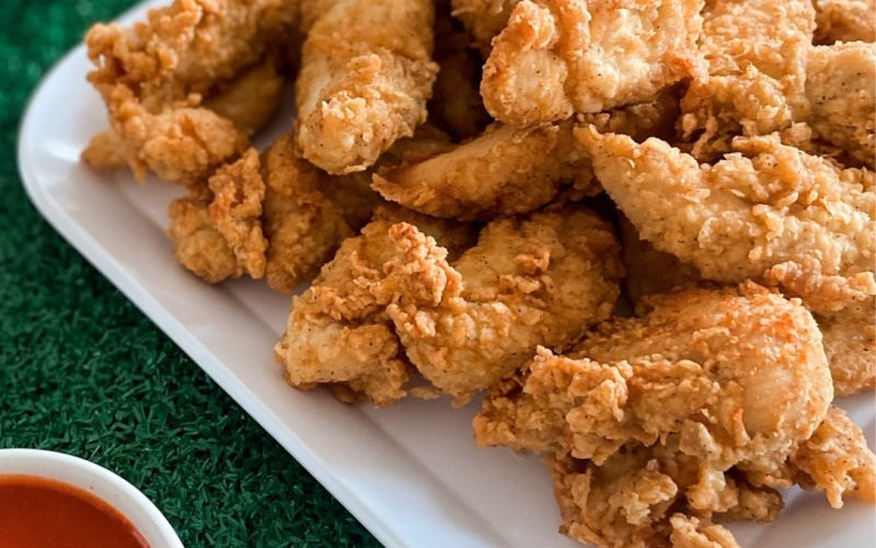 Otter’s Chicken catering tenders spread Otter’s Chicken catering tray of chicken tenders and dipping sauces