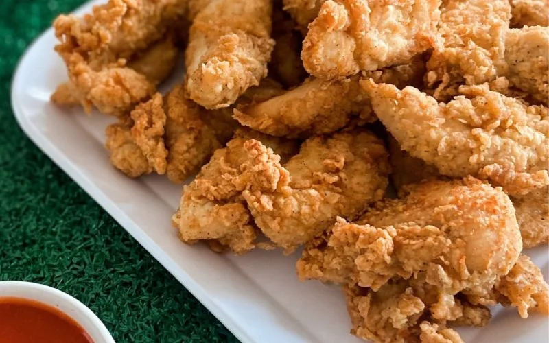Otter’s Chicken catering tenders spread Otter’s Chicken catering tray of chicken tenders and dipping sauces